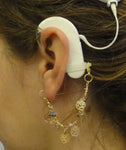 Boucle d’oreilles de maintien pour aide auditive ou processeur d’implant