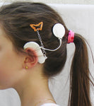 Pince cheveux de maintien pour aide auditive ou processeur d’implant