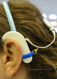 Système de maintien pour prothèse auditive ou processeur d'implant
